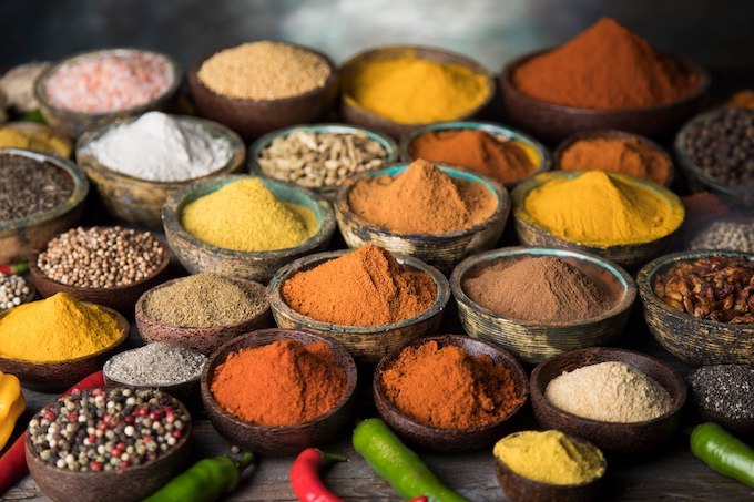 Italian premium herbs, spices, and seasoning blends including oregano, rosemary, chili flakes, and mixed Mediterranean spice jars