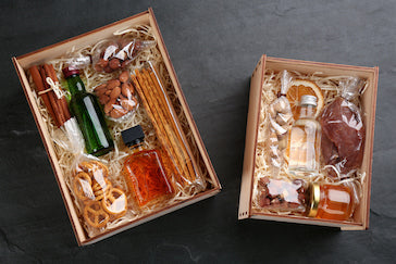 Assorted gourmet gift boxes with Italian olive oil, artisanal pasta, chocolates, and holiday treats – perfect for seasonal and curated gifting