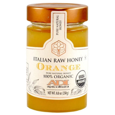 Glass jars of ADI Italian honey in assorted flavors on rustic wooden table