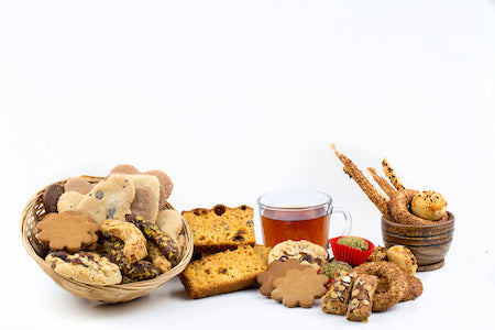 Artisan Italian biscotti with almonds and chocolate arranged on a rustic wooden tray next to an espresso cup